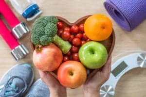 Bowl of fruit with exercise equipment