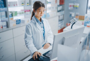 woman on the computer at a pharmacy