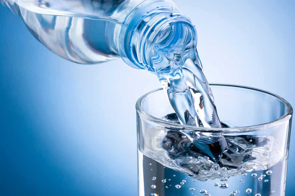 water bottle being poured into glass