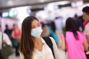 woman wearing surgical mask in airport