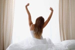 woman stretching out of bed