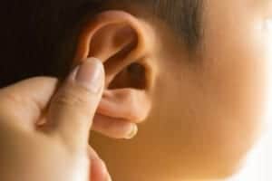 person holding ear