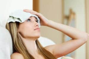 woman with cold compress on head