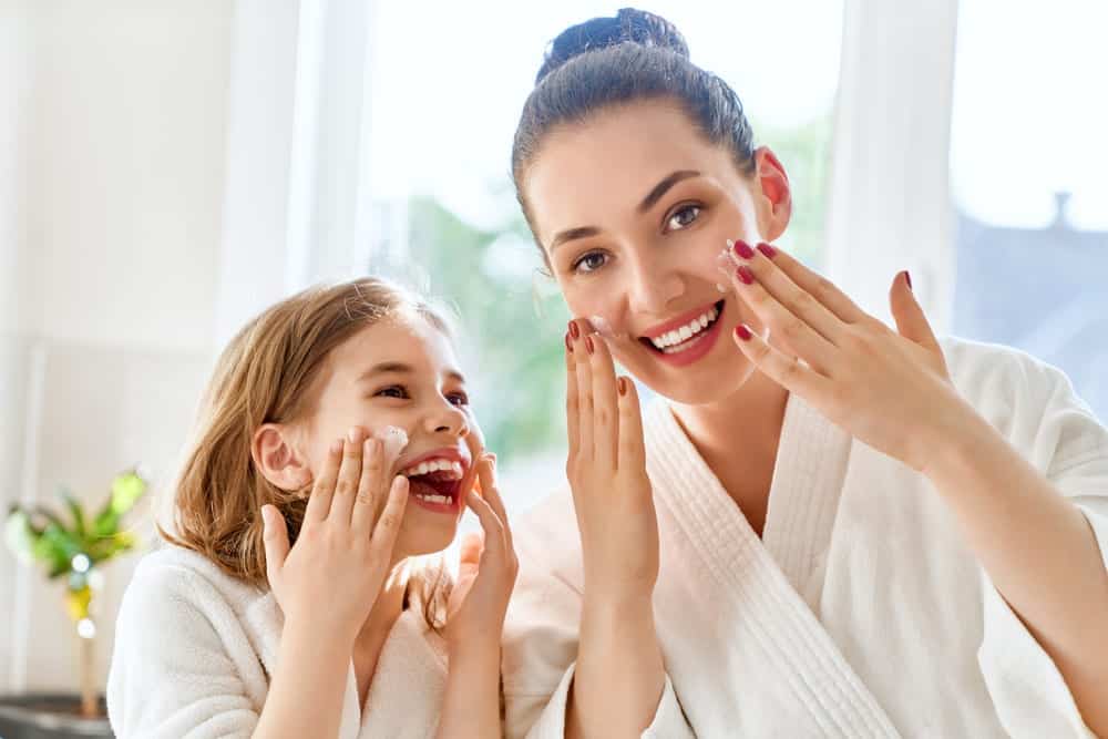 A mom and daughter taking care fo their skin