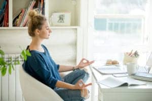 girl meditating at her desk