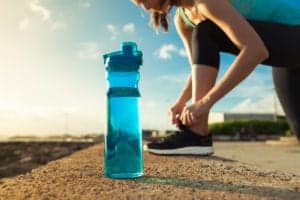 woman getting ready to run with her water bottle