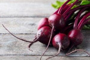 raw beets on a wooden surface