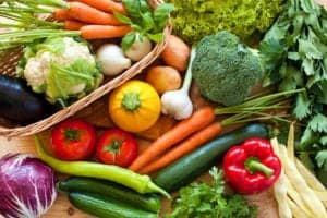 assortment of raw vegetables sitting on a table